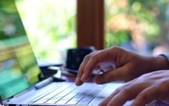 hands typing on a laptop keyboard