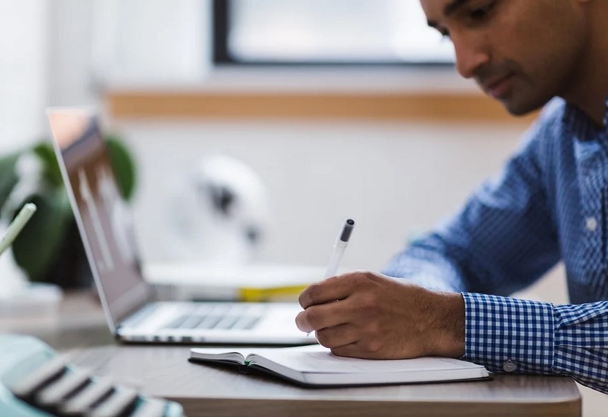 young man researching on a computer